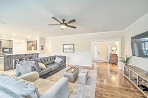 a living room with a couch and a ceiling fan at Pet-Friendly Tulsa Escape with Private Hot Tub! in Tulsa