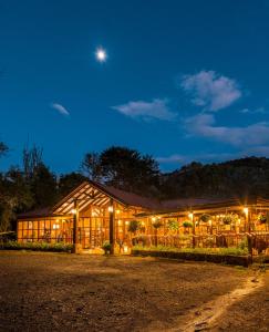 a building at night with the moon in the sky at Hotel de Montaña Suria in San Gerardo de Dota