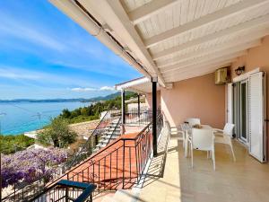 a balcony with a view of the water at Nissaki Apartments and Vasilis House in Nisaki