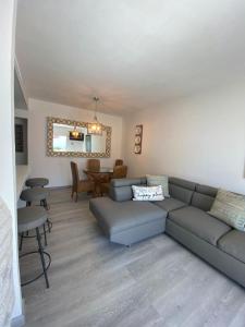 a living room with a couch and a table at Great Beach Swiming Pools Tennis Courts Condo in La Paloma Rosarito Beach in Rosarito