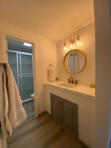 a bathroom with a sink and a mirror at Great Beach Swiming Pools Tennis Courts Condo in La Paloma Rosarito Beach in Rosarito