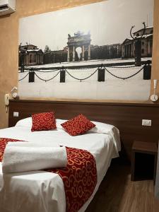 two beds in a room with a painting on the wall at Albergo Corvetto Corso Lodi in Milan