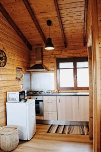 a kitchen with a sink, stove and a window at Vale do Rossim Eco Resort in Gouveia