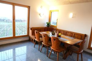 a dining room with a wooden table and chairs at Weinbergshof Rickel in Kitzingen