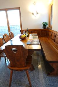 a wooden dining room table with a bowl of fruit on it at Weinbergshof Rickel in Kitzingen