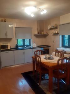 a kitchen with a wooden table and a dining room at Casa Grilo in Geres +12 photos