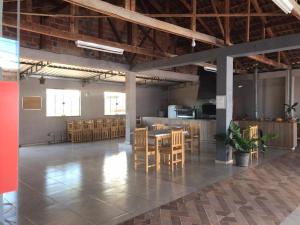 a large room with wooden tables and chairs at Hotel Dom Alcides in Nova Santa Medianeira