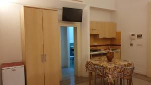 a kitchen with a table with a vase on it at Ad Maiora Salento in Lecce