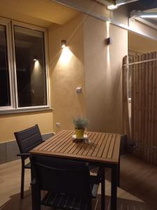 a wooden table and chairs in a room at Bamboo in Procida