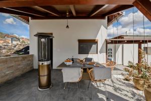 an outdoor dining area with a table and chairs at GouldVilla Vendégház in Villány