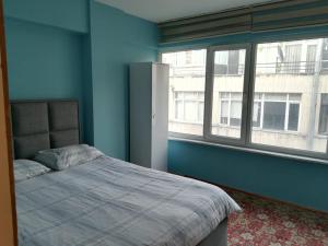 a bedroom with a bed and a large window at Setpark Apart Otel in Bursa