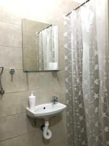 a bathroom with a sink and a mirror at Soba Milojkovic in Golubac +27 photos
