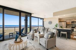 a living room with a view of the ocean at Sand & Sea: Room 308 in Seaside