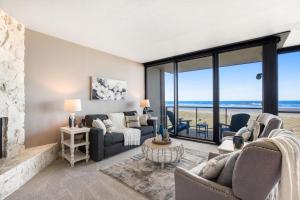 a living room with a view of the ocean at Sand & Sea: Room 308 in Seaside