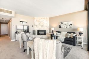 a living room with a couch and a fireplace at Sand & Sea: Room 308 in Seaside