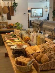 a table with many different types of bread and pastries at Penzion Pibernik in Bled