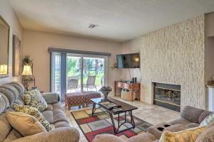 a living room with couches and a fireplace at Palm Desert Country Club Home with Pool Access! in Palm Desert