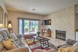 a living room with couches and a fireplace at Palm Desert Country Club Home with Patio and Grill! in Palm Desert