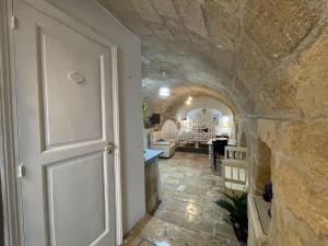 a door to a room with a stone wall at IL PUMO BLU in Polignano a Mare