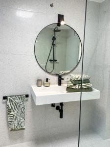 a bathroom with a white sink and a mirror at Ferienwohnung Ava No3- Heiligkreuztal 2-3 Personen in Heiligkreuztal