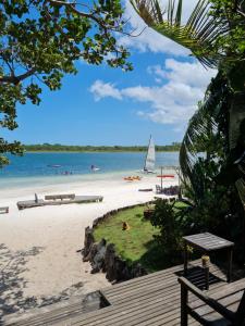 a beach with a sail boat in the water at Pousada e Restaurante do Paulo in Jijoca de Jericoacoara