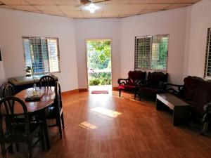 a living room with a table and a couch at Jungle cottage in Sreemangal