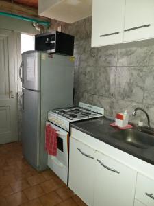 A kitchen or kitchenette at Departamentos Muñoz