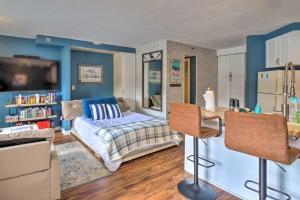 sala de estar con paredes azules y nevera. en Chic Winter Park Studio with Community Hot Tub, en Winter Park