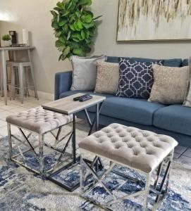a living room with a blue couch and a table at Ultra Glam Apartment 6 Miles From Hard Rock Stadium and Casino in Hollywood