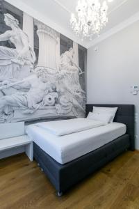 two beds in a room with a painting on the wall at Room 55 in Vienna