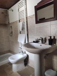 a bathroom with a white sink and a toilet at B&B Masseria Nardelli in Locorotondo +33 photos