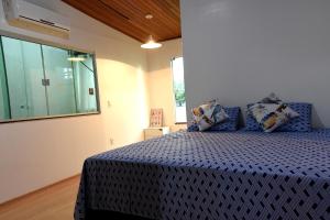 a bedroom with a blue bed in a room at FLAT W3 Norte in Brasília