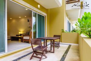 a dining room with a table and chairs at Pueblito Escondido by Mistik Vacation Rentals in Playa del Carmen