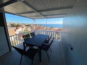 uma mesa e cadeiras numa varanda com vista em Maritom Apartments em Baška Voda