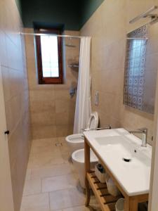 a bathroom with a sink and a toilet at La casa nel Borgo in Scopello +10 photos