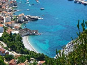 a view of a beach with boats in the water at Komiza Provita Guesthouse in Komiža
