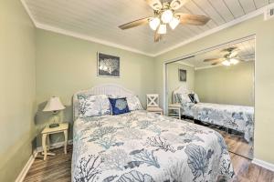 a bedroom with a bed and a ceiling fan at Fernandina Beach Condo about 1 Mi to Golf Courses in Fernandina Beach +31 photos
