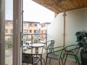 a balcony with chairs and a table and a table at Stone's Throw in Charlestown