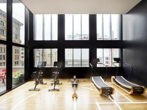 a gym with a bunch of exercise bikes in a room with windows at citizenM Los Angeles Downtown in Los Angeles