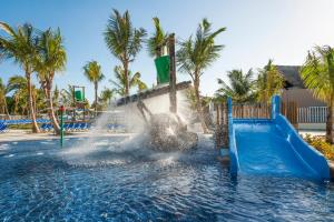 a water slide at a resort with a fountain at Royalton Splash Punta Cana, An Autograph Collection All-Inclusive Resort & Casino in Punta Cana