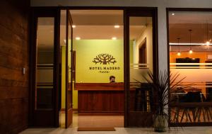 a glass door of a restaurant with a sign on it at Hotel Madero Talca in Talca