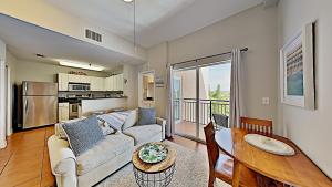 a living room with a couch and a table at Madeira Bay Resort II by Travel Resort Services in St Pete Beach