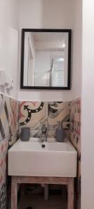 a bathroom with a white sink and a mirror at The Summer Treat Shared Apartment Compartido in Corralejo