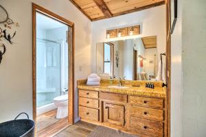 a bathroom with a sink and a mirror at Groveland Cabin with Outdoor Perks and Game Room in Groveland +30 photos