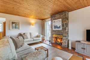 a living room with a couch and a fireplace at Inshcraig in Kincraig