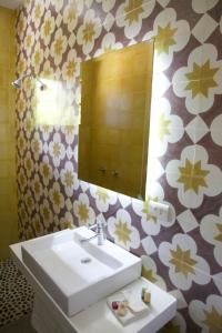 a bathroom with a sink and a mirror at La Betulia Bed and Breakfast in Oaxaca City