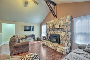 a large living room with a large stone fireplace at Peaceful Little Doll House Cabin with Grill! in Mi-Wuk Village