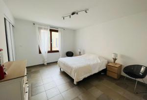 een witte slaapkamer met een bed en een raam bij Grand'Rue Malaucène in Malaucène