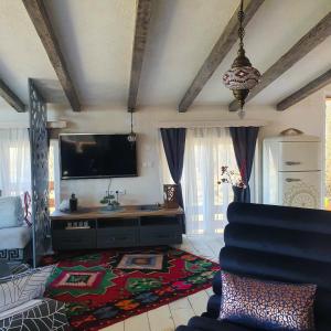 a living room with a flat screen tv and a couch at Apartment Little Paradise in Visoko