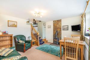 a living room with a table and a chair at Journeyman Loft in Skipton